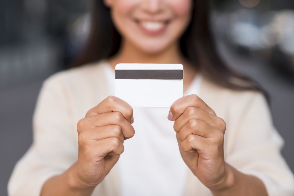 smiley woman holding credit card